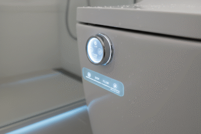 Close-up of the control knob for an integrated bidet toilet system, showing options for personalized cleansing.