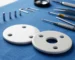 A detailed close-up of two polished ceramic discs from a high-quality faucet cartridge, explaining leak-proof technology.